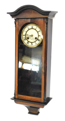 A Fred Hall of Pinchbeck mahogany cased wall clock, with cream Roman numeric dial, ebonised outer moulded border, and glazed single panel door, 70cm high.