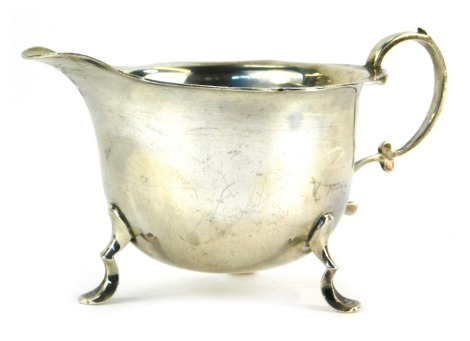 An Edward VII silver cream jug, with shaped rim, raised on three hoof supports, Birmingham 1903, 2.91oz, 5.5cm high.