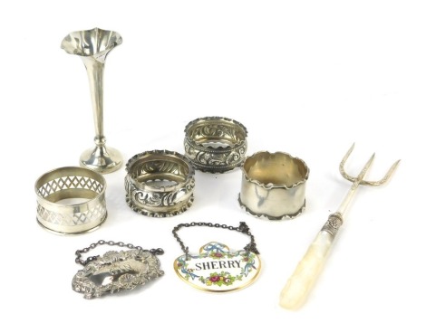 A group of small silver, to include four napkin rings, of differing form, a decanter label for gin, London 1974, pickle fork with mother of pearl handle, etc., weighable silver 2oz.