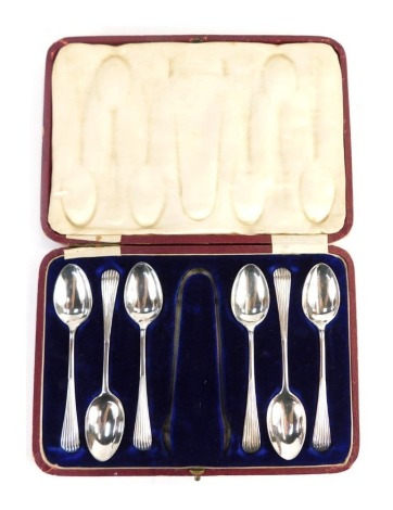 A set of six George V silver teaspoons, each handle with raised line decoration, Sheffield 1911, 3.08oz, in fitted box lacking sugar tongs.