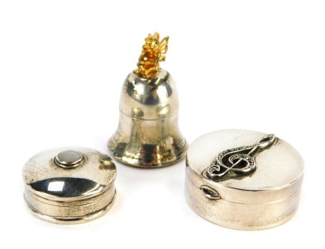 Three silver trinket boxes, comprising a cylindrical box, the top decorated in relief with a treble clef, London 1970, 3.5cm diameter, a further circular box, top inset with mother of pearl, marked 925, and a silver tooth fairy box, 4cm high.