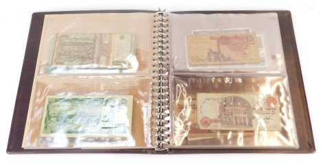 An album containing world banknotes, for Czechoslovakia, Iraq, Egypt, Brazil, Isle of Man, Greece, etc.