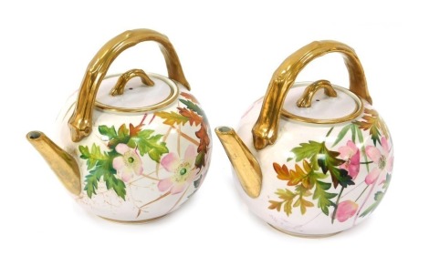 Two late 19thC French porcelain teapots, each with pink floral decoration and bamboo effect gilt handle, knop and spout, marked Chana C De Vine 2/8/87, 18cm high.