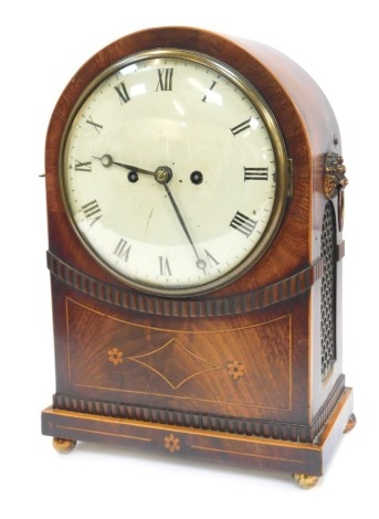 A 19thC mahogany cased bracket clock, the circular enamel dial bearing Roman numerals, eight day, the case of arched form, inlaid with boxwood floral motifs, with cast metal lion mask and ring handles to each side, raised on four brass orb feet, 42cm high