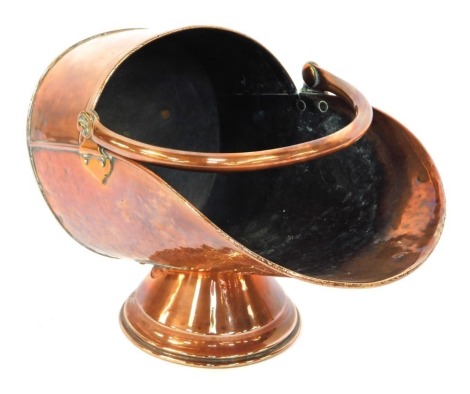 A late 19thC/early 20thC copper helmet shaped coal scuttle, 33cm high.