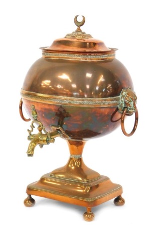 A Victorian copper and brass tea urn, with crescent moon shaped finial and lion mask ring handles, 53cm high.