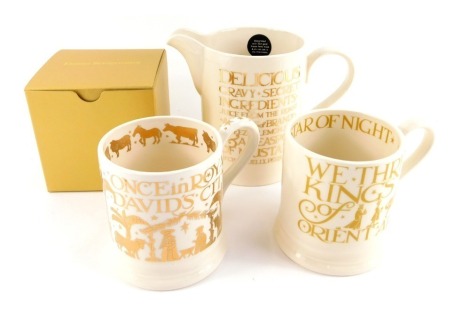 A group of Emma Bridgewater pottery, comprising a Gold Toast gravy jug, 13cm high, a Once in Royal David City mug, 10cm high, boxed, and a We Three Kings mug, 10cm high.