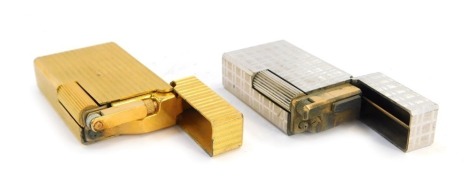 Two Flaminare pocket lighters, comprising a ribbed brass cased example, 6cm high, and a steel finish cross hatched lighter, 5cm high. (2)