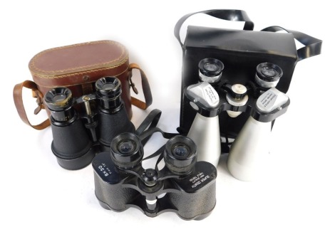 Three pairs of binoculars, comprising a Super Zenith 8x30 field binoculars, a cased set of racing binoculars in leather carry case, and a set of Charles Frank 12x50 binoculars. (3)