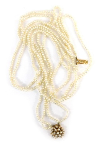 A two double strand pearl choker, with star clasp set with cultured pearl, yellow metal stamped 9kt, 47cm long, 30.6g all in.