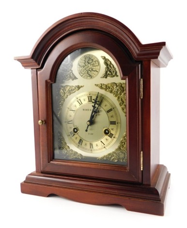 A 20thC mahogany cased mantel clock, the brass dial with a Roman numeral chapter ring for Wood and Sons, cherub spandrels, the dial marked 31 day, key wind, the case 36cm high.