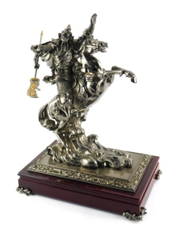 A 20thC cast metal figure group, depicting a Japanese warrior on rearing horseback, on wooden stand, with cast metal embellishments to corners, 50cm high.