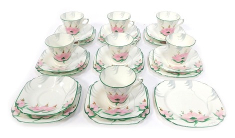 A Collingwood Art Deco style part tea service, decorated with pink and green flowers against a white ground, to include seven tea cups and saucers, and nine cake plates.