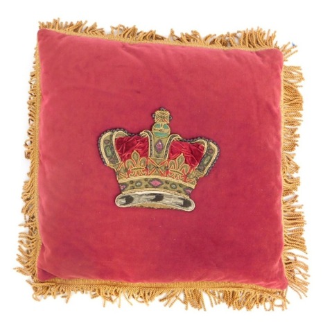 A 20thC red velvet cushion, with central embroidered crown motif, surrounded by gold coloured fringing, 49cm x 49cm.