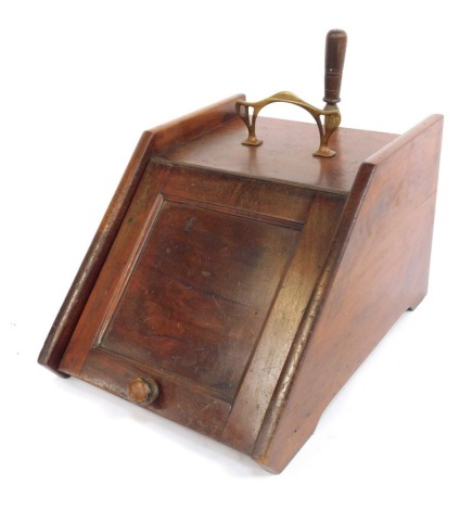 An early 20thC oak coal scuttle, with brass handle and shovel.