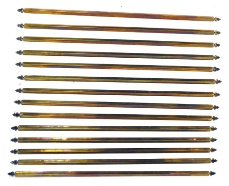 A group of brass stair rods.