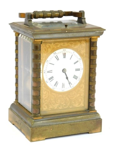 A 19thC French brass cased mantel clock, with circular white enamel dial bearing Roman and Arabic numerals, set within a foliate scroll engraved rectangular plate, the case of typical form with banded columns, twin barrel movement, key wind, with ring han