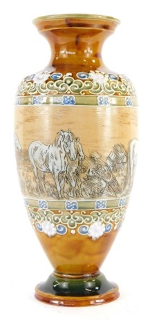 A Doulton Lambeth stoneware vase by Hannah Barlow, of cylindrical tapering form with flared neck and foot, decorated centrally with incised scene depicting horses before bales of hay, within floral bands, against a mustard yellow ground, impressed marks t