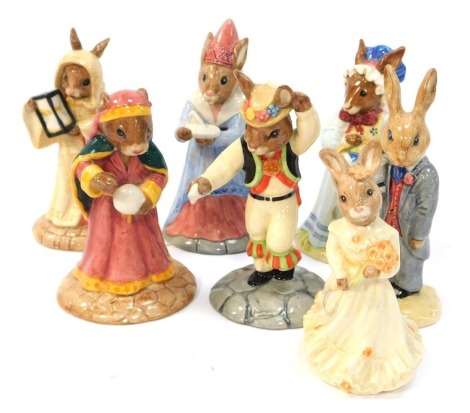 Six Royal Doulton Bunnykins figures, modelled as Morris Dancer Bunnykins DB208, Groom Bunnykins DB102, Fortune Teller Bunnykins DB218, Sundial Bunnykins DB213, Mrs Bunnykins at the Easter Parade DB19, Sands of Time Bunnykins DB229, and Bridesmaid Bunnykin