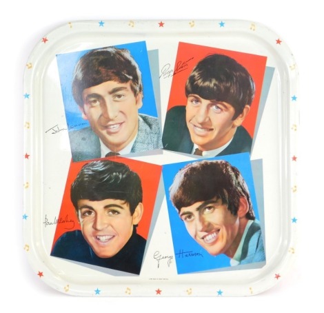 The Beatles tin tray by Worcester Ware, depicting a photographic print of the members, against a white ground, with an alternating musical symbol and star border, 33cm x 33cm.