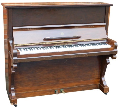 A 20thC mahogany cased upright piano by Rud. Bich & Son Barmen Germany, overstrung, retailed by Harrods Ltd.