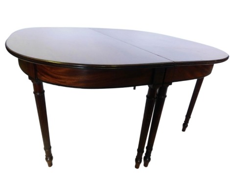 A 19thC mahogany dining table, comprising two large D shaped sections, each with a moulded edge, a plain frieze on turned reeded tapering legs, 73cm high, 145cm wide, 147cm long.