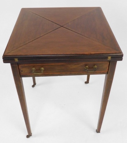 An Edwardian mahogany card table, with boxwood inlaid border, and green baize lined interior on tapered legs, terminating in castors, 74cm high, the top, 56cm x 56m.