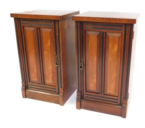 A pair of late 20thC mahogany pot cupboards, each with a moulded and banded door, with ebonised detail, 73cm high, 41cm wide, 36cm deep.