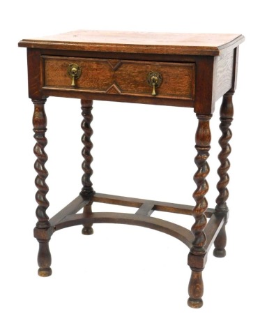 A 1930s oak side table, the rectangular top above an arrangement of single drawer, on barley twist legs, 73cm high, 57cm wide, 40cm deep.