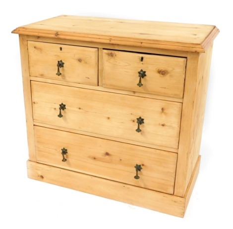 A stripped pine chest, of two short and two long drawers, with brass floral drop handles on block base, 83cm high, 84cm wide, 48cm deep.