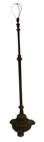 A Victorian brass standard lamp, with a fluted column, raised on a fluted triform base, raised on disc feet, 171cm high.