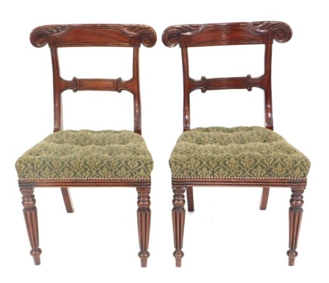 A pair of William IV mahogany side chairs, with a carved bar back, a Damask upholstered padded seat, on turned reeded legs.