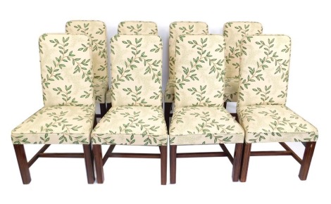 A set of eight dining chairs, each upholstered in leaf and cream upholstery. (AF)