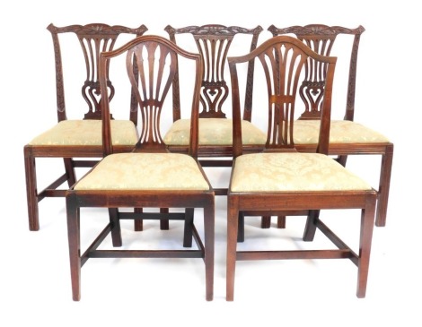 Five George III mahogany dining chairs, each with a pierced splat and a drop in seat, on square tapering legs.