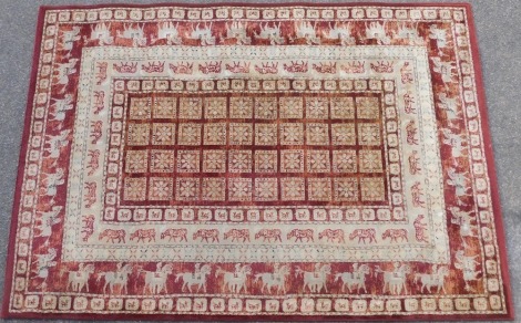 A Master Craft Noble Art Belgian machine woven rug, on a red ground, 160cm x 230cm.