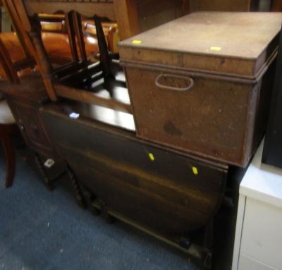 An oak gate leg table, together with a metal trunk, 52cm wide.