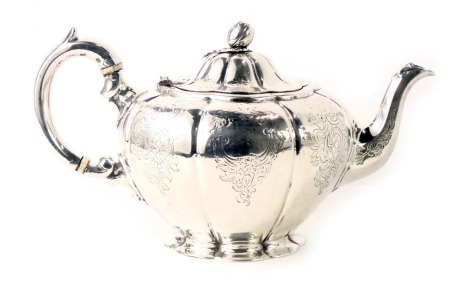 A Victorian silver teapot, with acorn finial, and engraved crosshatch and scroll pattern, with ivory handle, maker JS AS, London 1841, 19.40oz.