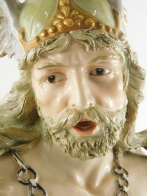 An Ernst Wahliss Austrian porcelain figural bust, modelled in the form of a soldier, wearing a hat with feathers, chain mail, sword, etc. on a rococo base embellished with flowers and berries, printed mark to underside and numbers, 48cm high. (AF) - 2