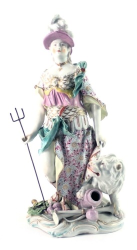 A continental porcelain figure of Britannia in Derby style, standing beside a lion, carrying a trident, on rococo scroll base, patch marks to underside but possibly Samson, 32cm high.