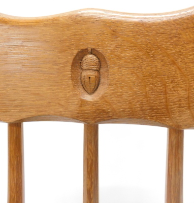 An Alan 'Acornman' Grainger oak rocking chair, with spindle turned back, solid seat and shaped arms, on faceted legs with rockers, in the manner of Mouseman. - 2