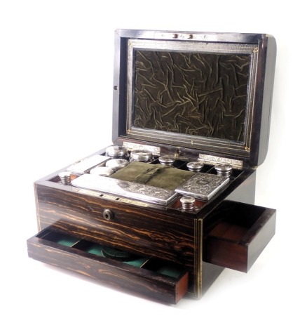 A Victorian Coromandel and brass inlaid dressing case, the hinged top with circular engraved cartouche with monogram enclosing fitted interior with jars, bottles, etc., each engraved with monogram and with foliate scroll design, with the exception of two 