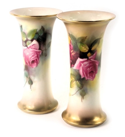 A pair of Royal Worcester blush ivory porcelain wasted cylindrical vases, painted with roses, printed marks in green to underside and shape number G923, 19.5cm high.