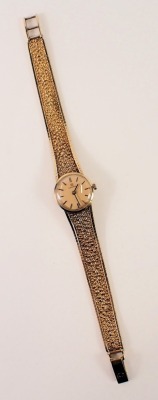 A 9ct gold Omega lady's wristwatch, the gold coloured circular dial, 1.5cm wide, on a bark effect bracelet, 24.8g all in. - 5