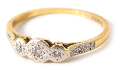 An 18ct gold and plat diamond dress ring, with three illusion set tiny diamonds, and two tiny diamond markers to each shoulder, set in platinum on a yellow metal band, ring size N½, 2g all in.