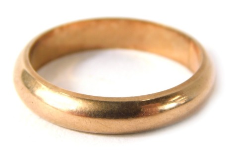 A rose gold wedding band, of plain design, yellow metal stamped 9ct, ring size T½, 5.1g all in.