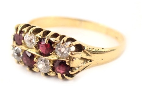 A ruby and diamond two row dress ring, each set with four rubies and four diamonds, in claw setting on a yellow metal band, with rubbed marks, possibly 18ct, ring size M½, 3.4g all in.