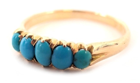 A five stone turquoise dress ring, the oval turquoise of graduated design set in claw setting on a plain band, yellow metal stamped 18ct, ring size N½, 2.4g all in.