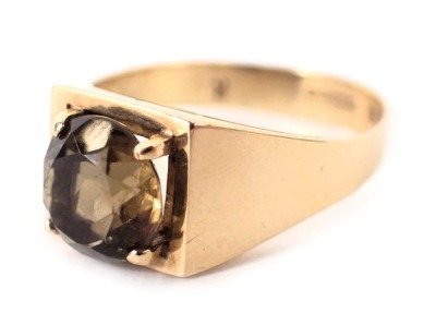 A 9ct gold smokey quartz dress ring, the square set ring head with round brilliant cut citrine in four claw setting, on plain band, ring size P, 3.6g all in.