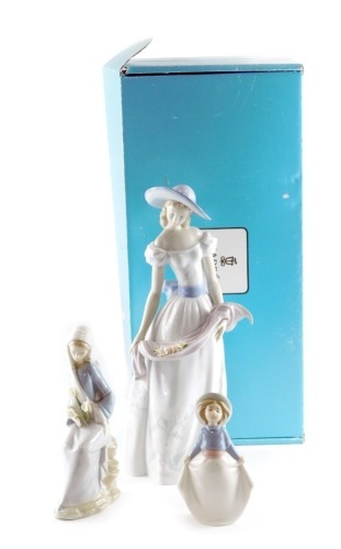 A large Lladro porcelain figure of a lady with flowers, Fragrances and Colours, model number E662X, 40cm high, a further Lladro figure and a Nao figure. (3)