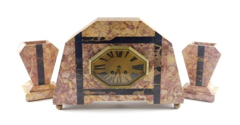 A French Art Deco purple and black variegated marble clock garniture, the clock with octagonal bezel and Roman numeric dial, on bun feet, 38cm wide, the vases 18cm high.